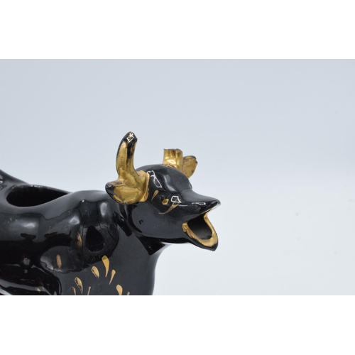 198B - A pair of earthenware 20th century Staffordshire-style cow creamers in Jackfield manner (2) (horns d... 