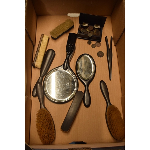 217 - A collection of ebonised wooden brushes, trinket box, hand held mirrors etc (Qty).