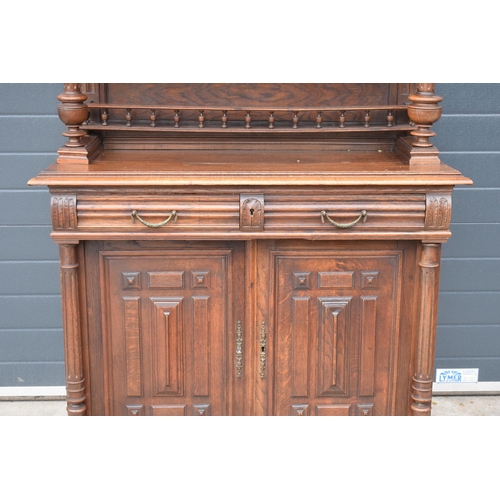 250 - An early 20th century wooden kitchen dresser with glazed upper doors and carved decoration. 218cm ta... 