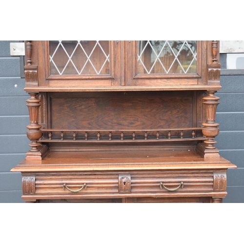 250 - An early 20th century wooden kitchen dresser with glazed upper doors and carved decoration. 218cm ta... 