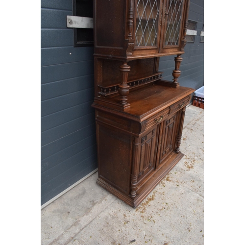 250 - An early 20th century wooden kitchen dresser with glazed upper doors and carved decoration. 218cm ta... 