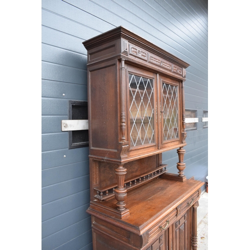 250 - An early 20th century wooden kitchen dresser with glazed upper doors and carved decoration. 218cm ta... 