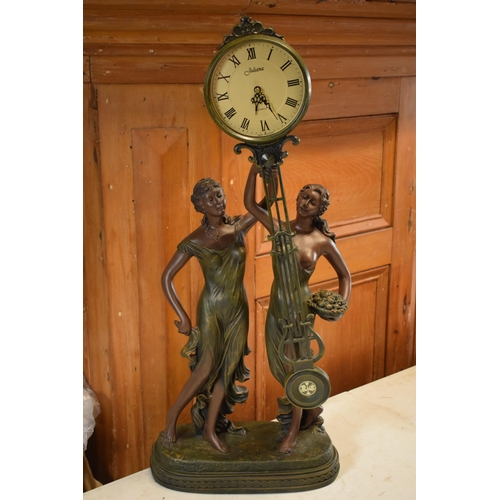 257 - A contemporary Julianna Studios swinging mantle clock in the form of 2 ladies in robes holding it to... 