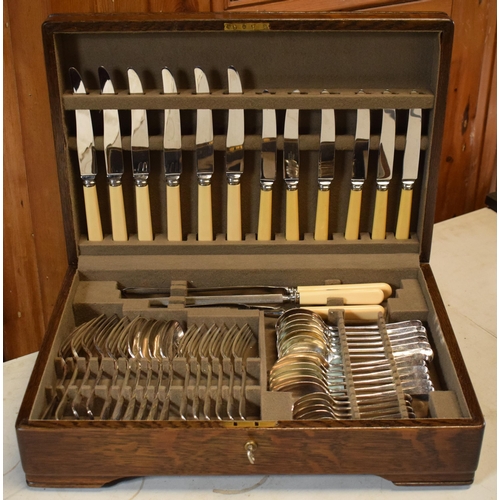 261 - A vintage boxed Mappin and Webb oak cased cutlery canteen (all complete and as new) with dedication ... 