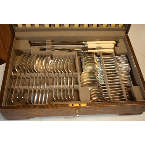 261 - A vintage boxed Mappin and Webb oak cased cutlery canteen (all complete and as new) with dedication ... 