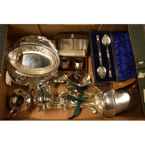 265 - A collection of silver plated items to include cutlery sets, a basket, cream jugs, cutlery and a Piq... 