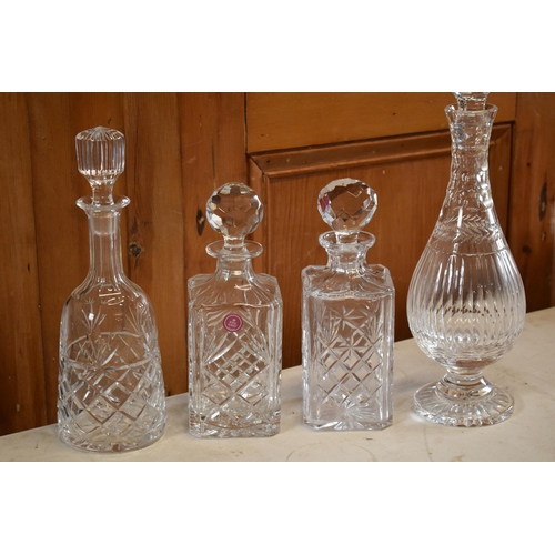 267 - A collection of decanters to include a Royal Albert cut glass examples and 3 similar examples.