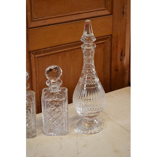 267 - A collection of decanters to include a Royal Albert cut glass examples and 3 similar examples.