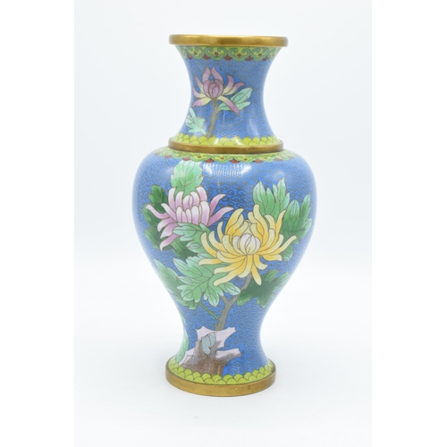 268 - A Japanese Cloisonné vase with lilies on a blue background, 26.5cm tall.