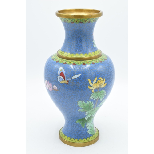 268 - A Japanese Cloisonné vase with lilies on a blue background, 26.5cm tall.