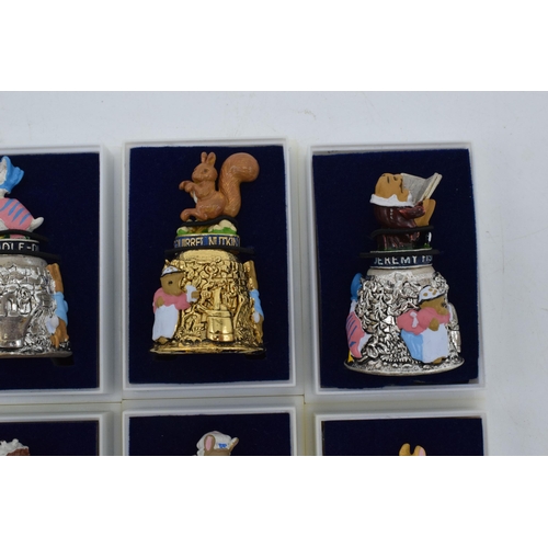 274 - A collection of Beatrix Potter Centenary gold plated thimbles together with 6 silver plated figural ... 