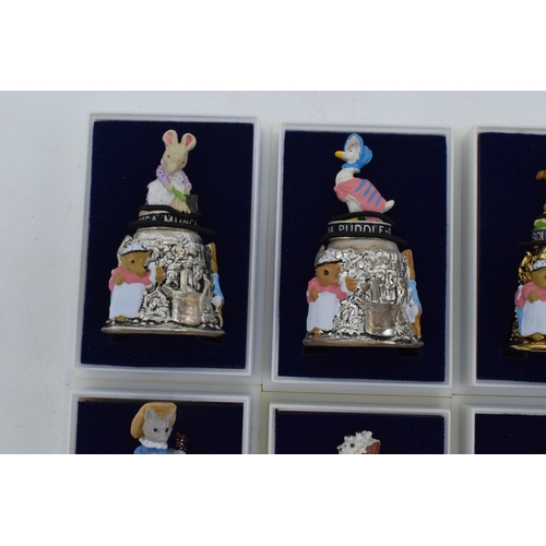 274 - A collection of Beatrix Potter Centenary gold plated thimbles together with 6 silver plated figural ... 