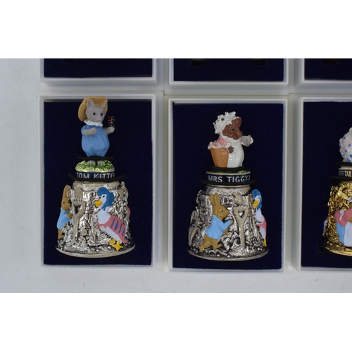 274 - A collection of Beatrix Potter Centenary gold plated thimbles together with 6 silver plated figural ... 