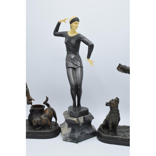 297 - A pair of bronzed spelter figures in the form of boys with animals and a Art-Deco style resin figure... 