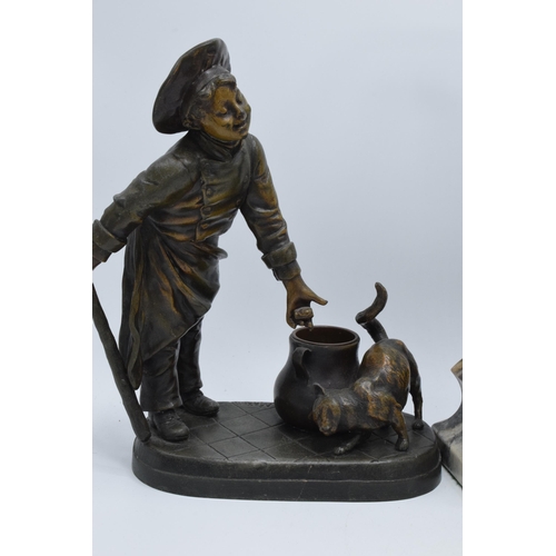 297 - A pair of bronzed spelter figures in the form of boys with animals and a Art-Deco style resin figure... 