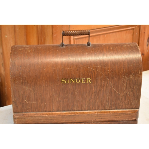 300 - A cased Singer sewing machine.