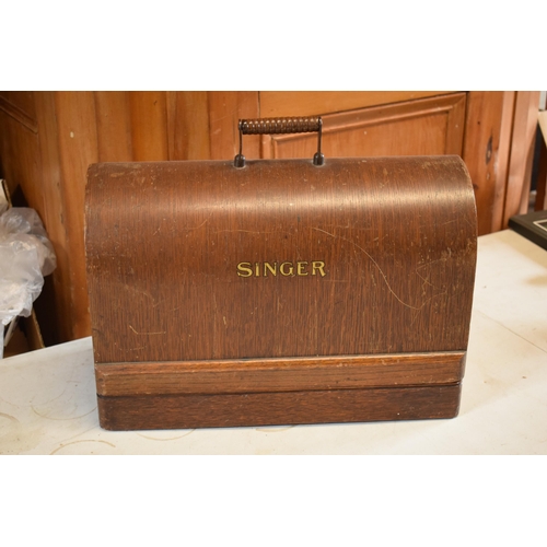 300 - A cased Singer sewing machine.