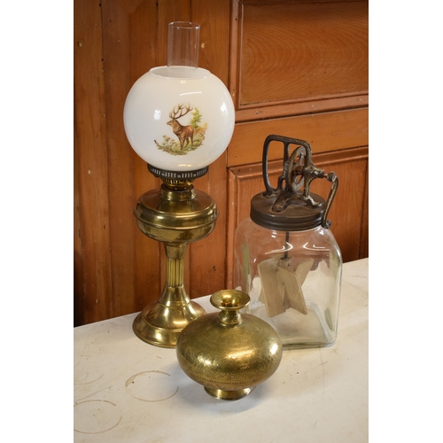 302 - A mixed collection of items to include a vintage hand-propelled butter churn, brass oil lamp and bra... 