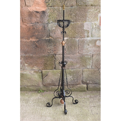 303 - A tall and adjustable metal and copper freestanding lamp with twisted iron work, 156cm tall.