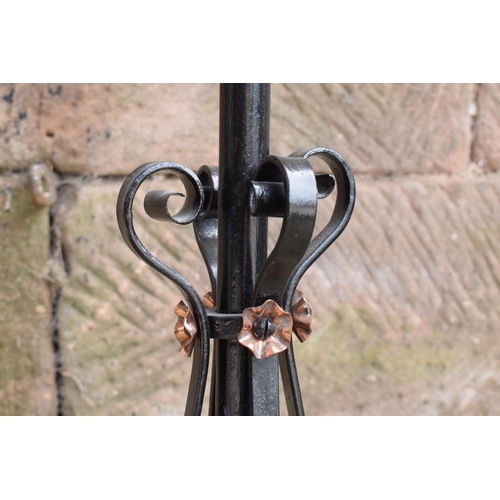 303 - A tall and adjustable metal and copper freestanding lamp with twisted iron work, 156cm tall.