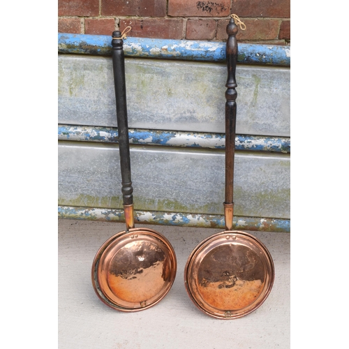 305 - A pair of 19th century copper bed pans with wooden handles (2).