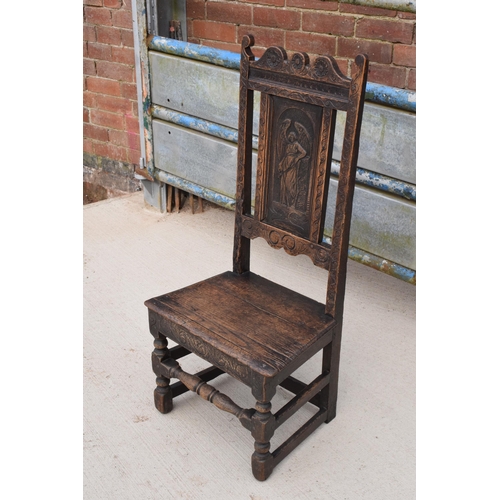 306 - An early to mid 19th century Wainscot-style oak chair with carved back panel, 108cm tall.