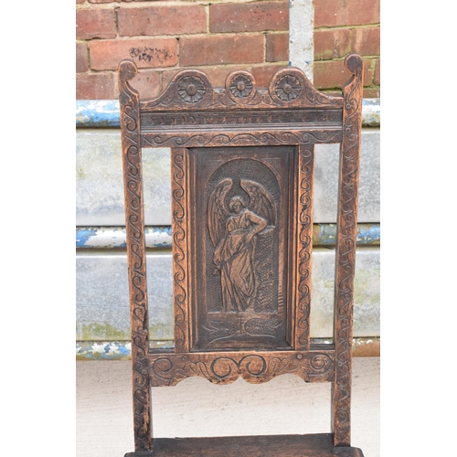 306 - An early to mid 19th century Wainscot-style oak chair with carved back panel, 108cm tall.