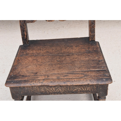 306 - An early to mid 19th century Wainscot-style oak chair with carved back panel, 108cm tall.