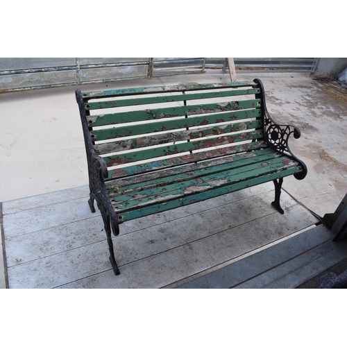 309 - A 20th century wooden and cast iron bench with wooden slats, 126cm wide.