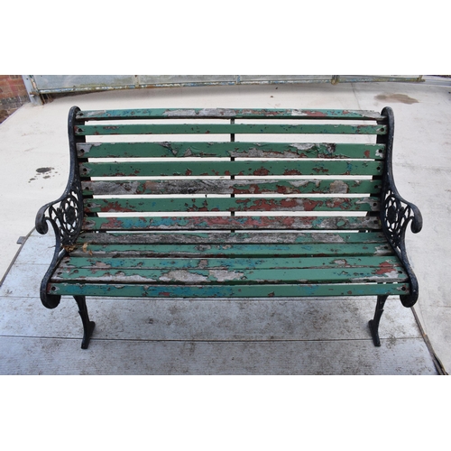 309 - A 20th century wooden and cast iron bench with wooden slats, 126cm wide.