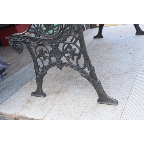 309 - A 20th century wooden and cast iron bench with wooden slats, 126cm wide.