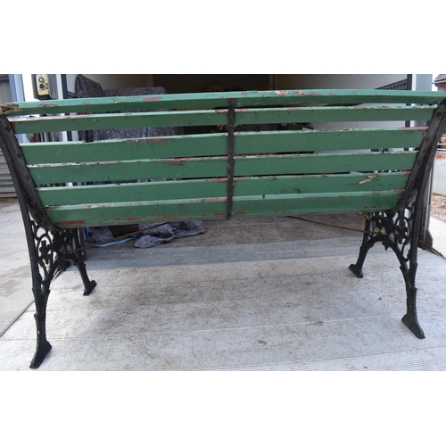 309 - A 20th century wooden and cast iron bench with wooden slats, 126cm wide.