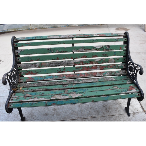 309 - A 20th century wooden and cast iron bench with wooden slats, 126cm wide.