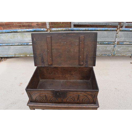 310 - An 18th century oak bible box with carved decoration to front set on 19th century oak frame, 69cm wi... 