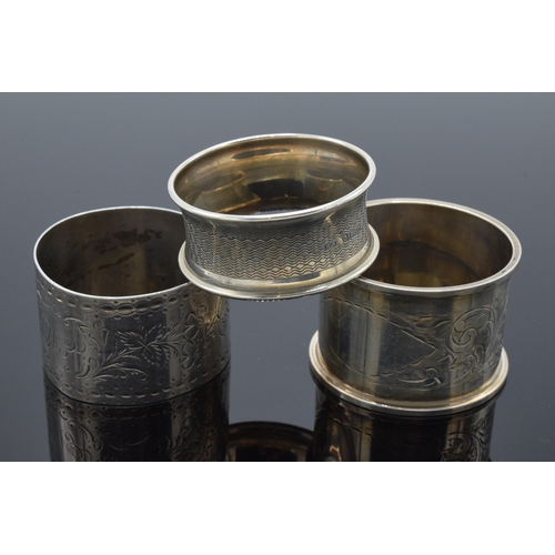 323 - A trio of silver napkin rings to include Birmingham 1897, 1917 and Chester 1905 (3). 52.3 grams.