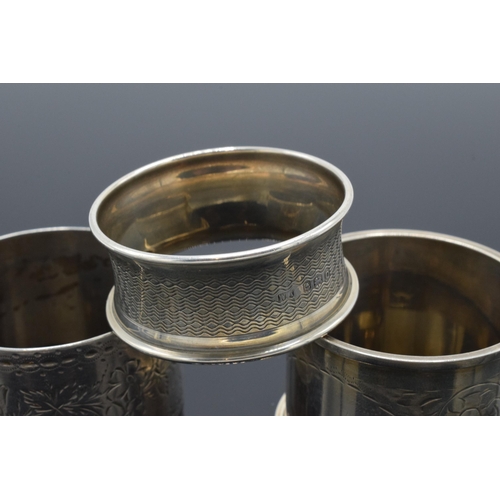 323 - A trio of silver napkin rings to include Birmingham 1897, 1917 and Chester 1905 (3). 52.3 grams.