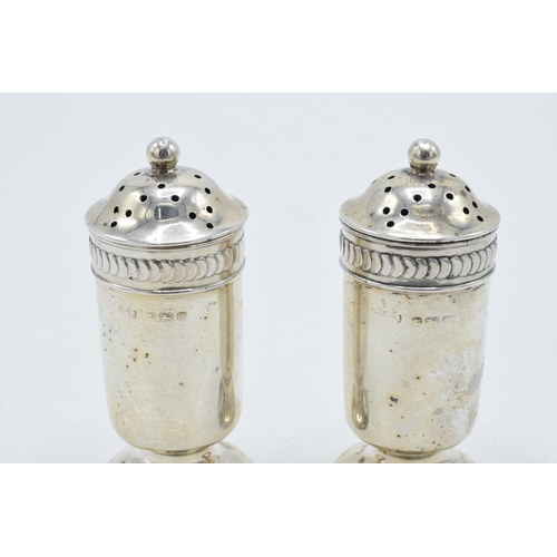 328 - A pair of silver shakers, 62.2 grams. 7.5cm tall. Birmingham 1910.