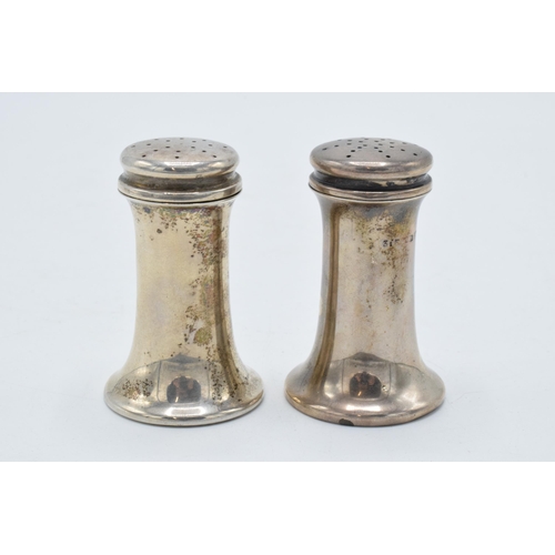 329 - A pair of silver shakers 48.7 grams. Birmingham 1911. 6cm tall.