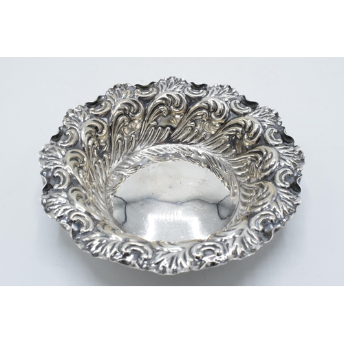 335 - Silver sweet / bonbon dish with repousse decoration. Sheffield 1897. 51.0 grams. 12cm diameter.