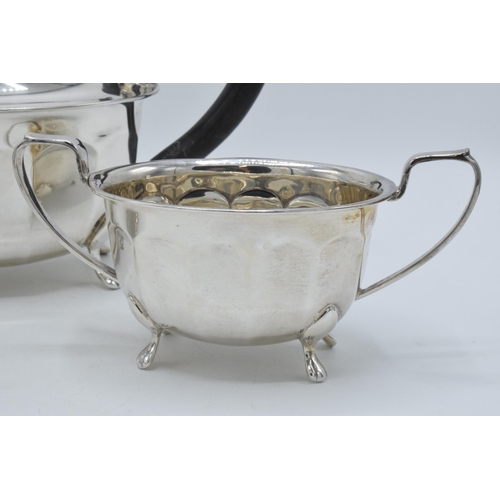 344 - A silver 3-piece tea set to include a teapot with ebonised handle, sugar bowl and milk jug (3). Gros... 