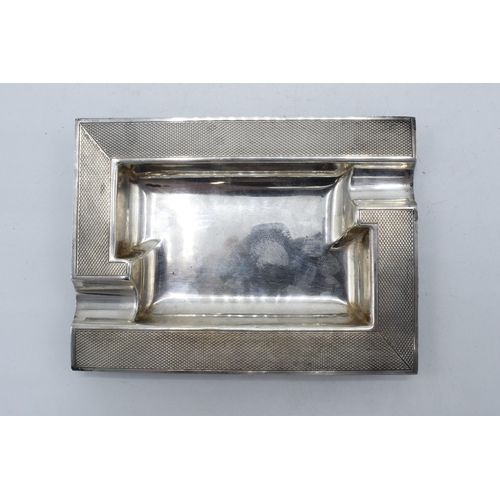 351 - A silver ashtray with engineered decoration, Birmingham 1959, Suckling Ltd. 63.6 grams. 11x8cm.