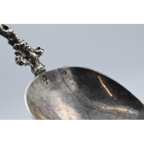 359 - A silver spoon with ornate handle and figural finial, presumed Dutch, with English assay marks. 52.1... 