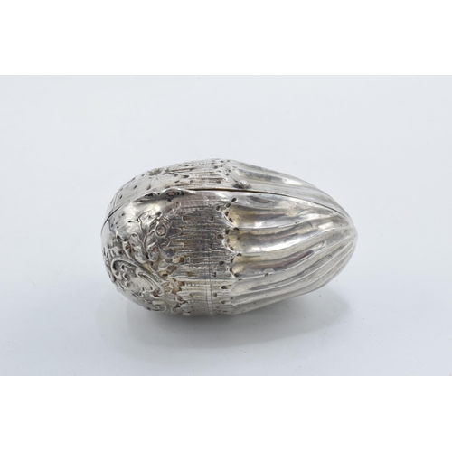 368 - A silver nut-shaped storage capsule for spice / nutmeg etc with repousse decoration and continental ... 