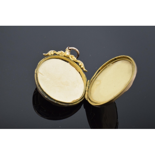 406 - 9ct gold oval hinged locket set with seed pearls and sapphire with engraved decoration with metal in... 