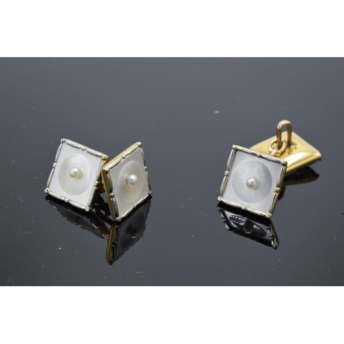 412 - A pair of 9ct gold and platinum cufflinks with Mother of Pearl and seed pearl design (2). 5.6 grams.