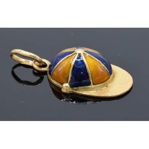 413 - 18ct gold and enamel jockey's cap charm. 1.5 grams. 17mm long.