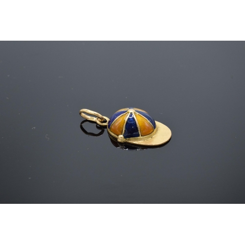 413 - 18ct gold and enamel jockey's cap charm. 1.5 grams. 17mm long.