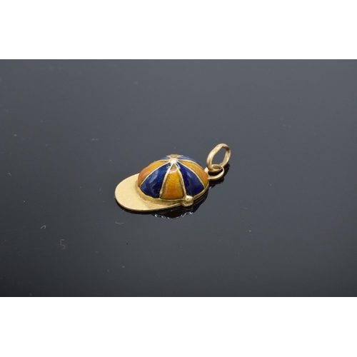 413 - 18ct gold and enamel jockey's cap charm. 1.5 grams. 17mm long.