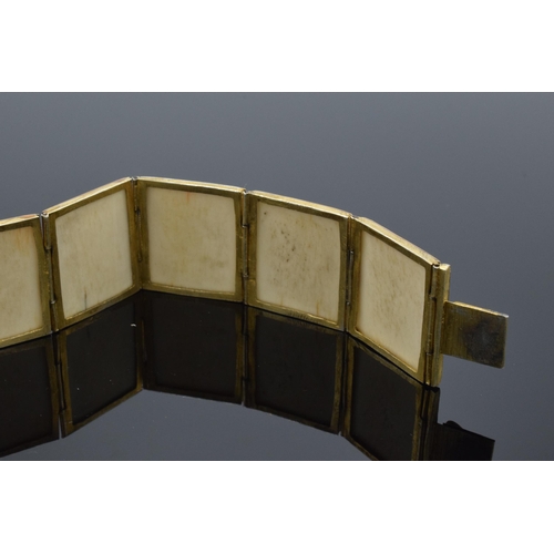 414 - Yellow metal and oriental panel bracelet. 19.5cm long.