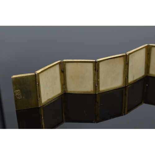 414 - Yellow metal and oriental panel bracelet. 19.5cm long.